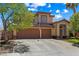 Lovely two-story home with a wide driveway, mature landscaping, and an inviting front entrance at 2042 Maple Springs St, Henderson, NV 89002