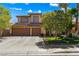 Charming two-story home featuring a well-maintained lawn, mature trees, and a spacious two-car garage at 2042 Maple Springs St, Henderson, NV 89002
