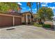 Attractive home showcasing a manicured lawn, a two-car garage, and a charming covered entry at 2042 Maple Springs St, Henderson, NV 89002