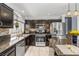 Modern kitchen with granite countertops, stainless steel appliances, and dark wood cabinetry at 2042 Maple Springs St, Henderson, NV 89002