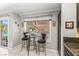 Bright kitchen nook with backyard views, complemented by granite counters and stylish lighting at 2042 Maple Springs St, Henderson, NV 89002