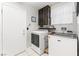 Functional laundry room with modern appliances, storage cabinets, and a bright window at 2042 Maple Springs St, Henderson, NV 89002