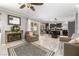 Spacious open-concept living room with a fireplace, kitchen view, and stylish decor at 2042 Maple Springs St, Henderson, NV 89002