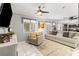 Open-concept living room with a TV, natural light, and seamless flow into the kitchen at 2042 Maple Springs St, Henderson, NV 89002
