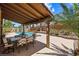 Backyard patio with a covered dining area overlooking the sparkling pool and lush landscape at 2042 Maple Springs St, Henderson, NV 89002