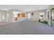 Open-concept living room with carpet, leading to a kitchen and backyard access, filled with natural light at 2110 Fort Sanders St, Henderson, NV 89052