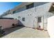 Backyard view features a door, white privacy wall and a small seating area at 225 Pecos Way, Las Vegas, NV 89121
