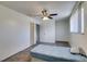 Spacious bedroom featuring carpet floors, a ceiling fan, and natural light from the window at 225 Pecos Way, Las Vegas, NV 89121