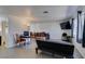 Open living room with light wood-look floors, neutral walls, with a window and dining area at 225 Pecos Way, Las Vegas, NV 89121