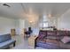 Open living space with view of the kitchen with light wood floors and white walls at 225 Pecos Way, Las Vegas, NV 89121
