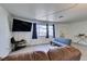 Bright living room with a mounted TV, windows with curtains, and neutral-toned flooring at 225 Pecos Way, Las Vegas, NV 89121