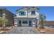 Charming two-story home featuring a paved driveway and cheerful blue accents at 2622 Begonia Falls Ave # 35, North Las Vegas, NV 89081