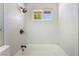 Clean bathroom features white tiled shower with window and dark fixtures at 2749 Del Mar Pl, Las Vegas, NV 89169