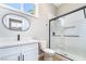 This updated bathroom features a glass enclosed shower, modern fixtures, and white finishes at 2749 Del Mar Pl, Las Vegas, NV 89169