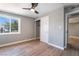 Bright bedroom features wood-look floors, a ceiling fan, a closet and a large window at 2749 Del Mar Pl, Las Vegas, NV 89169