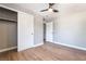 This bedroom features wood-look floors, a ceiling fan, and a closet with sliding doors at 2749 Del Mar Pl, Las Vegas, NV 89169