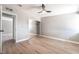 Bright bedroom features hardwood floors, ceiling fan, and mirrored closet at 2749 Del Mar Pl, Las Vegas, NV 89169