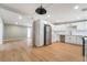 Modern kitchen with stainless steel appliances, white cabinets, and light wood flooring at 2749 Del Mar Pl, Las Vegas, NV 89169