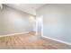 This expansive living room features wood-look floors and a doorway to a kitchen area at 2749 Del Mar Pl, Las Vegas, NV 89169