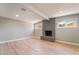 Cozy living room with a gray tiled fireplace and natural light from two windows at 2749 Del Mar Pl, Las Vegas, NV 89169