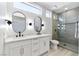Bright bathroom featuring double sinks, quartz countertops, and a glass enclosed shower with black fixtures at 2755 Darby Falls Dr, Las Vegas, NV 89134