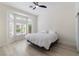 Bright bedroom featuring a bay window, modern ceiling fan, and hardwood flooring at 2755 Darby Falls Dr, Las Vegas, NV 89134