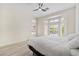 Cozy bedroom featuring a bay window with shutter shades, a ceiling fan, and a large bed at 2755 Darby Falls Dr, Las Vegas, NV 89134
