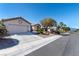 Charming single-story home featuring a spacious driveway and xeriscaped front yard with mature trees at 2755 Darby Falls Dr, Las Vegas, NV 89134