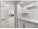 Hallway nook featuring white cabinets, quartz countertops, and gold accents at 2755 Darby Falls Dr, Las Vegas, NV 89134