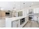 Gourmet kitchen features stainless steel appliances, quartz countertops, and a large island with modern fixtures at 2755 Darby Falls Dr, Las Vegas, NV 89134