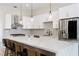 Bright kitchen features white cabinets, stainless steel appliances, and a large island with quartz countertops at 2755 Darby Falls Dr, Las Vegas, NV 89134