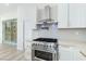 Close up of the kitchen featuring stainless steel stove, range hood and backsplash and lots of counter space at 2755 Darby Falls Dr, Las Vegas, NV 89134