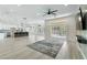 Bright, open-concept living room featuring modern lighting, flooring, and a sliding glass door at 2755 Darby Falls Dr, Las Vegas, NV 89134