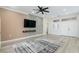 Living room featuring a textured wall, TV, and neutral decor, and hardwood flooring at 2755 Darby Falls Dr, Las Vegas, NV 89134