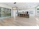 Bright, open-concept living room featuring modern flooring, a wine cellar, and leading into the kitchen at 2755 Darby Falls Dr, Las Vegas, NV 89134