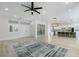 Bright, open-concept living room featuring modern flooring, a wine cellar, and leading into the kitchen at 2755 Darby Falls Dr, Las Vegas, NV 89134