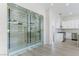 Modern climate-controlled wine cellar with glass doors, built-in racking, adjacent to the kitchen at 2755 Darby Falls Dr, Las Vegas, NV 89134