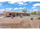 Spacious backyard featuring a covered patio, outdoor seating, and landscaping perfect for relaxing and entertaining outdoors at 2821 Moon Cir, Las Vegas, NV 89120