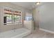 Bright bathroom with tub, walk-in shower, and serene backyard views at 2821 Moon Cir, Las Vegas, NV 89120