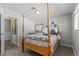 Charming bedroom with four-poster bed, enhanced by ample natural light and complemented by cozy decor at 2821 Moon Cir, Las Vegas, NV 89120