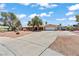 A single-story home featuring a wide driveway and desert-style front yard at 2821 Moon Cir, Las Vegas, NV 89120
