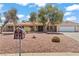 Front of a quaint home with desert landscaping, mature trees, and a mailbox at 2821 Moon Cir, Las Vegas, NV 89120