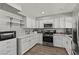 Bright kitchen features white cabinets, stainless appliances and granite countertops at 2821 Moon Cir, Las Vegas, NV 89120