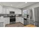 Well-equipped kitchen with white cabinets, granite countertops, and stainless steel appliances at 2821 Moon Cir, Las Vegas, NV 89120