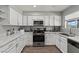 Bright kitchen features white cabinets, stainless appliances and granite countertops at 2821 Moon Cir, Las Vegas, NV 89120