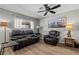 Inviting living room features a comfortable black leather sofa and chair set at 2821 Moon Cir, Las Vegas, NV 89120