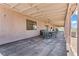 Long covered patio has a table and chairs for outdoor dining and entertaining at 2821 Moon Cir, Las Vegas, NV 89120