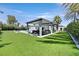 Large backyard featuring a covered outdoor living space, pool, and lush lawn at 324 Park Way, Las Vegas, NV 89106