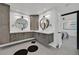 Dual sink bathroom featuring a round mirror, modern fixtures, and access to the bedroom at 324 Park Way, Las Vegas, NV 89106