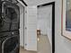 Convenient laundry area featuring a stacked washer and dryer, next to an office at 324 Park Way, Las Vegas, NV 89106